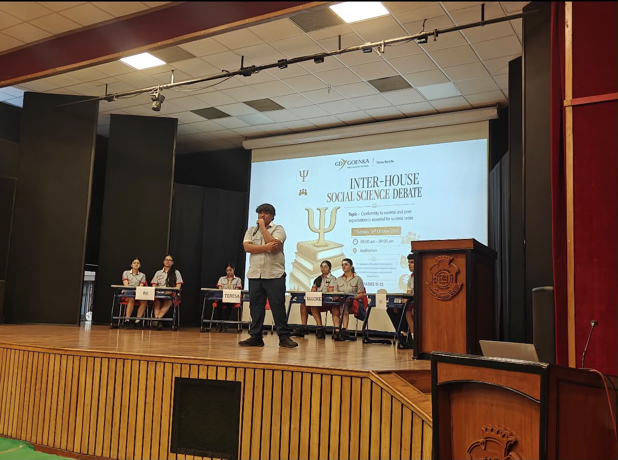 Smyan Bansal speaking on stage at the GD Goenka Inter-House Social Science Debate